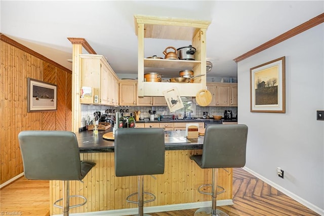 1973 Old Mountain Rd, Thomasville, NC 27360 - kitchen with dark countertops, a peninsula, backsplash, a breakfast bar area, and crown molding