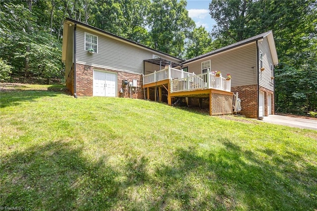 1973 Old Mountain Rd, Thomasville, NC 27360 - rear view of property featuring brick siding, a garage, driveway, a wooden deck, and a lawn