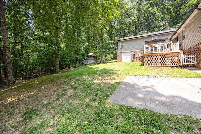 1973 Old Mountain Rd, Thomasville, NC 27360 - view of green lawn featuring a wooden deck and a patio area