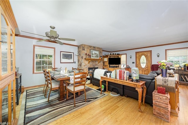 1973 Old Mountain Rd, Thomasville, NC 27360 - dining room with hardwood / wood-style flooring, plenty of natural light, ceiling fan, a stone fireplace, and crown molding