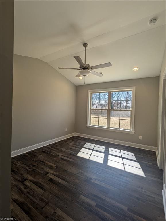 unfurnished room featuring baseboards, lofted ceiling, dark wood-type flooring, and ceiling fan