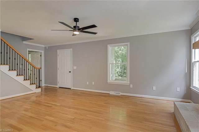 unfurnished living room featuring ceiling fan, light wood-type flooring, plenty of natural light, crown molding, and baseboards