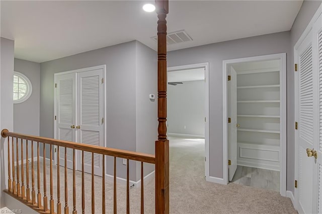 corridor with carpet and baseboards
