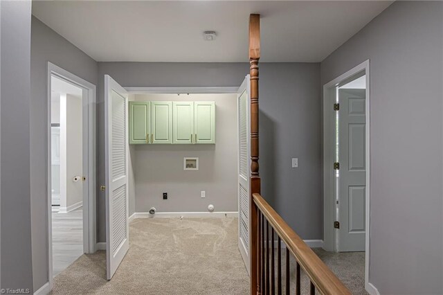 washroom with washer hookup, cabinet space, light colored carpet, hookup for a gas dryer, and baseboards
