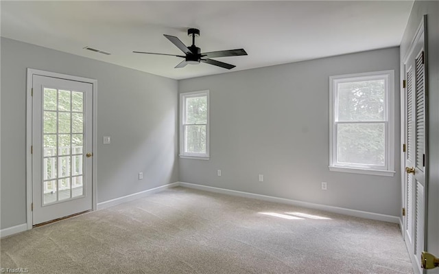 spare room featuring baseboards, ceiling fan, and carpet floors