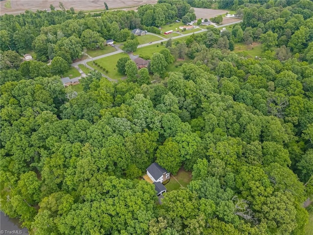 aerial view of property's location featuring a heavily wooded area