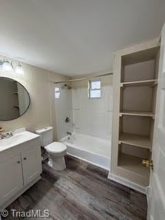 full bathroom with vanity, wood-type flooring, tiled shower / bath combo, and toilet