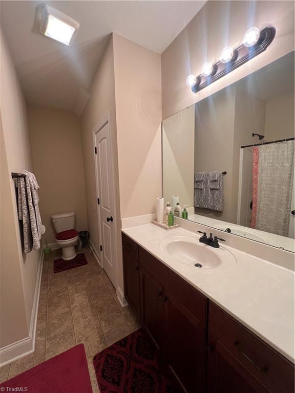 bathroom with toilet, vanity, and a shower with shower curtain