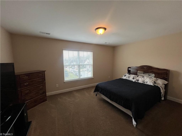 bedroom with dark colored carpet