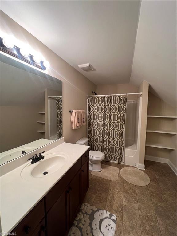 full bathroom featuring toilet, vanity, vaulted ceiling, and shower / tub combo with curtain