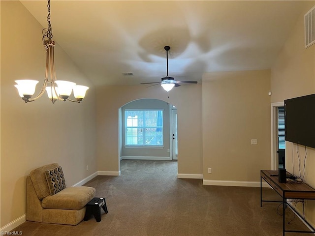 living room featuring ceiling fan with notable chandelier, dark carpet, and lofted ceiling