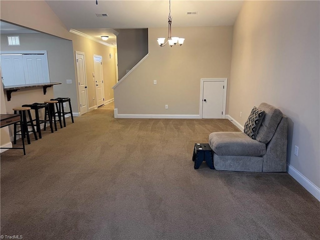 sitting room featuring crown molding, a chandelier, and carpet flooring