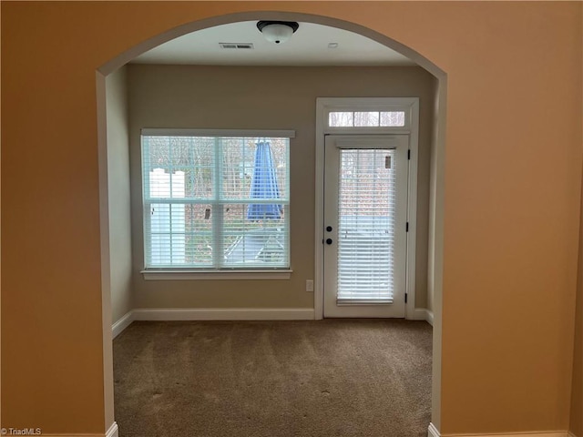 doorway to outside featuring carpet