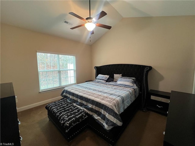 bedroom with ceiling fan, vaulted ceiling, and dark colored carpet