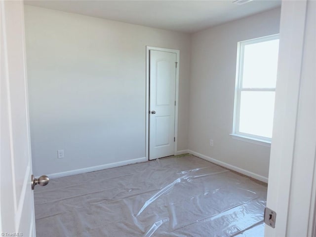 spare room with baseboards