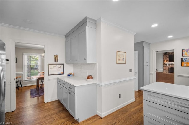 4105 Waldenbrook Rd, Greensboro, NC 27407 - kitchen with light countertops, wood finished floors, crown molding, and gray cabinetry