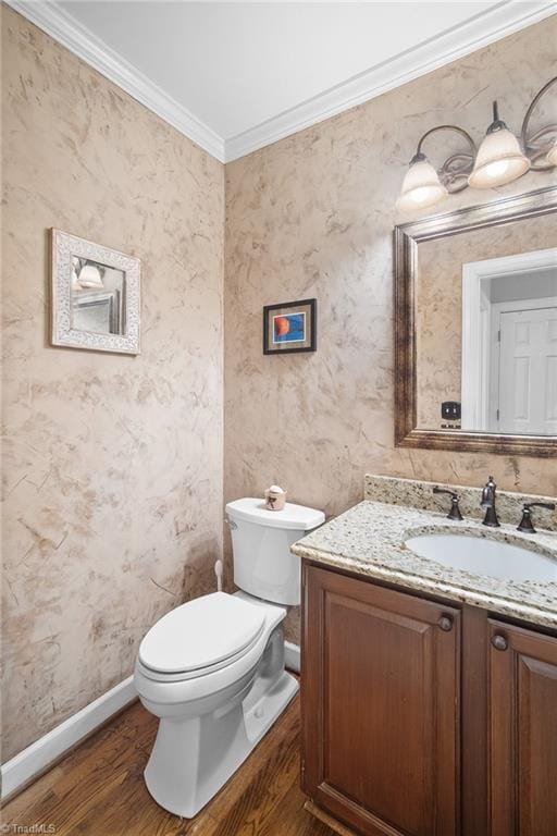 4105 Waldenbrook Rd, Greensboro, NC 27407 - half bathroom with wood finished floors, toilet, vanity, crown molding, and baseboards