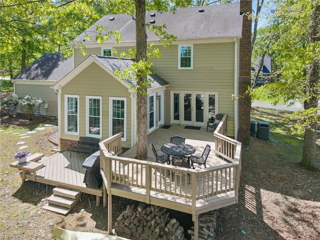 4105 Waldenbrook Rd, Greensboro, NC 27407 - back of house with central AC, a chimney, french doors, a wooden deck, and roof with shingles