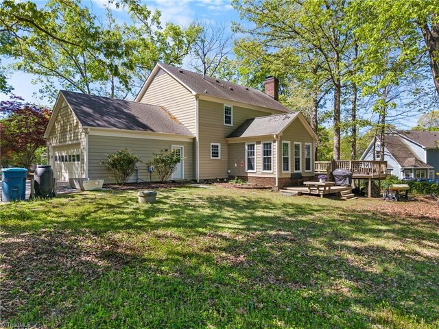 4105 Waldenbrook Rd, Greensboro, NC 27407 - back of house with an attached garage, a lawn, a chimney, and a wooden deck