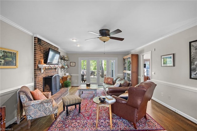 4105 Waldenbrook Rd, Greensboro, NC 27407 - living room with baseboards, wood finished floors, ceiling fan, a fireplace, and ornamental molding