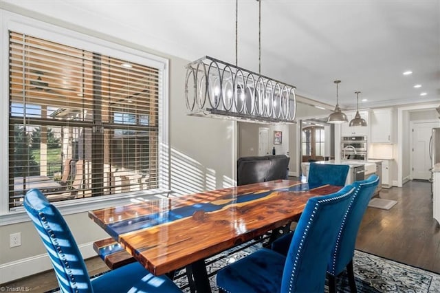 dining room with an inviting chandelier and dark wood-type flooring