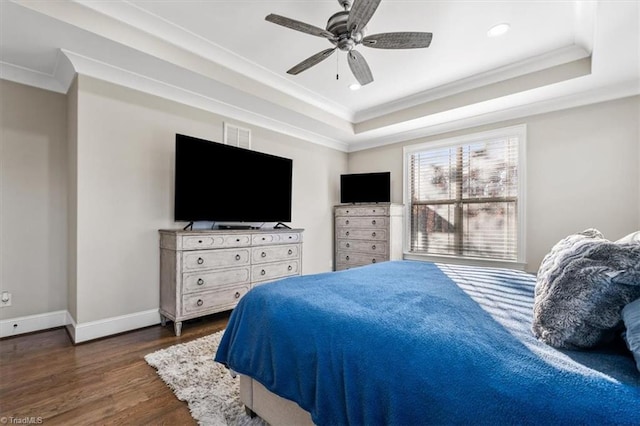 bedroom featuring a tray ceiling, ceiling fan, crown molding, and dark hardwood / wood-style floors