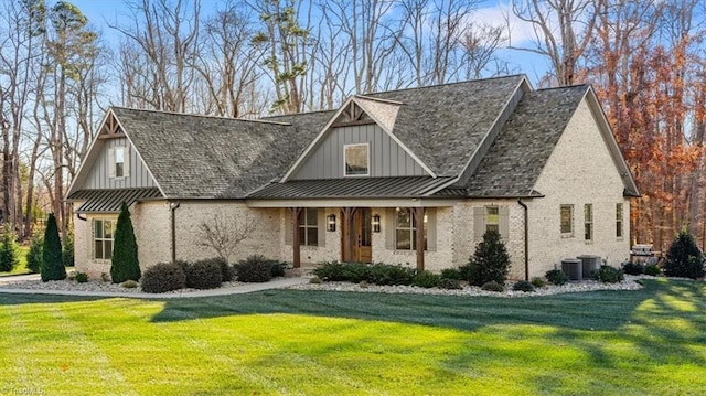 view of front of property with a front yard, a porch, and central AC unit