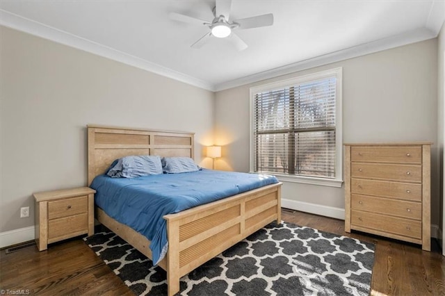 bedroom with dark hardwood / wood-style floors, ceiling fan, and ornamental molding