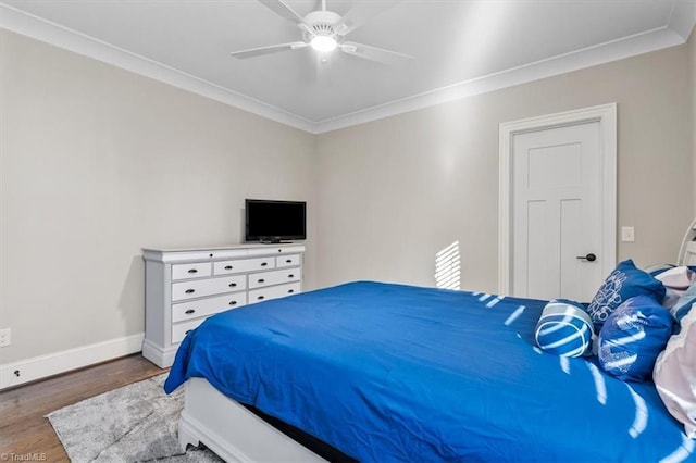 bedroom with ceiling fan, dark hardwood / wood-style flooring, and crown molding