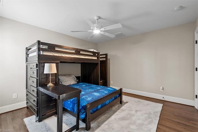 bedroom with ceiling fan and dark hardwood / wood-style flooring