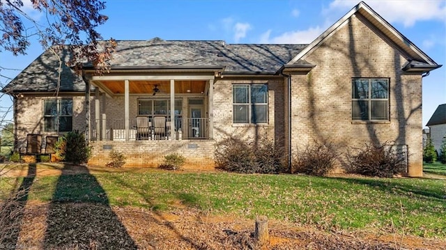 view of front of property with ceiling fan and a front yard