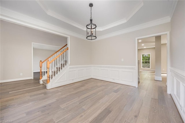 3510 Meadow Glen Ct, Clemmons, NC 27012 - spare room with a tray ceiling, crown molding, light wood-style floors, and stairs