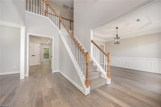 3510 Meadow Glen Ct, Clemmons, NC 27012 - staircase featuring a notable chandelier, crown molding, visible vents, and wood finished floors
