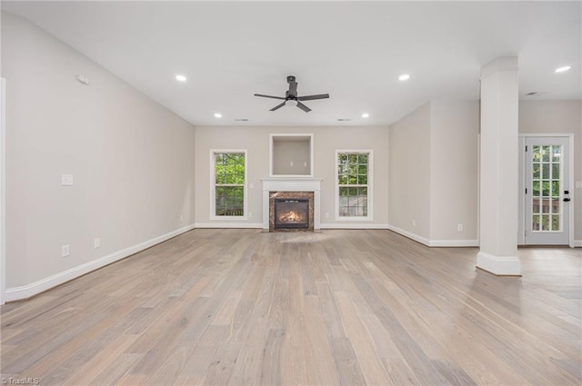 3510 Meadow Glen Ct, Clemmons, NC 27012 - unfurnished living room with light wood-style flooring, baseboards, a ceiling fan, and decorative columns