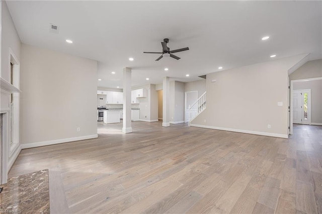 3510 Meadow Glen Ct, Clemmons, NC 27012 - unfurnished living room with stairway, a fireplace, light wood-style flooring, a ceiling fan, and baseboards