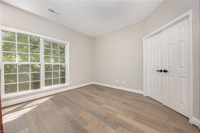3510 Meadow Glen Ct, Clemmons, NC 27012 - unfurnished bedroom featuring a closet, visible vents, wood finished floors, and baseboards