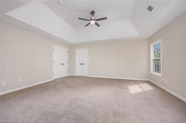 3510 Meadow Glen Ct, Clemmons, NC 27012 - carpeted empty room with a tray ceiling, visible vents, baseboards, and a ceiling fan