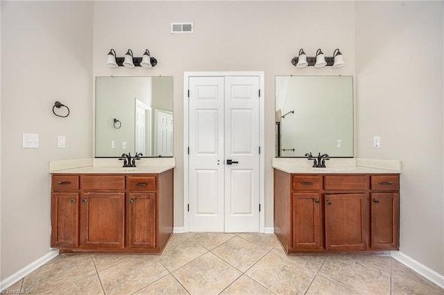 3510 Meadow Glen Ct, Clemmons, NC 27012 - bathroom featuring two vanities, baseboards, visible vents, and tile patterned floors