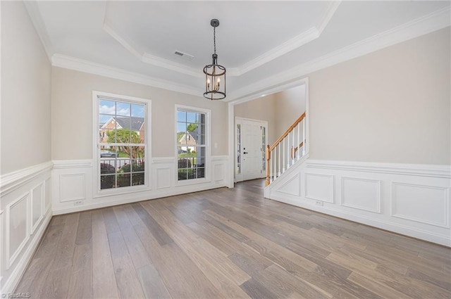 3510 Meadow Glen Ct, Clemmons, NC 27012 - interior space with a notable chandelier, a tray ceiling, visible vents, a wainscoted wall, and wood finished floors