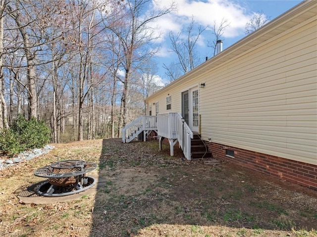 view of yard with an outdoor fire pit and a wooden deck