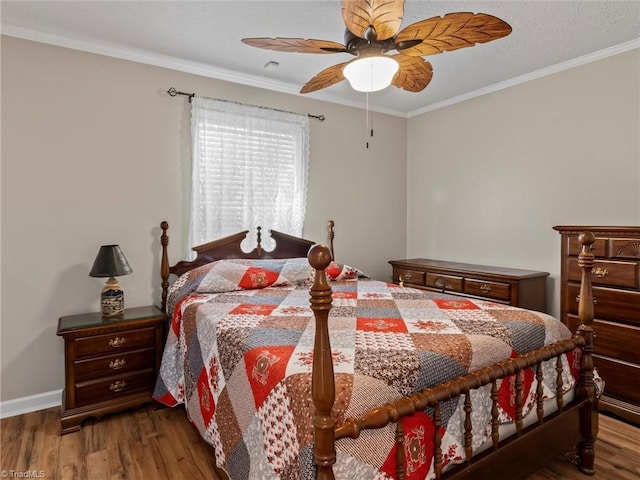 bedroom with ornamental molding, ceiling fan, baseboards, and wood finished floors