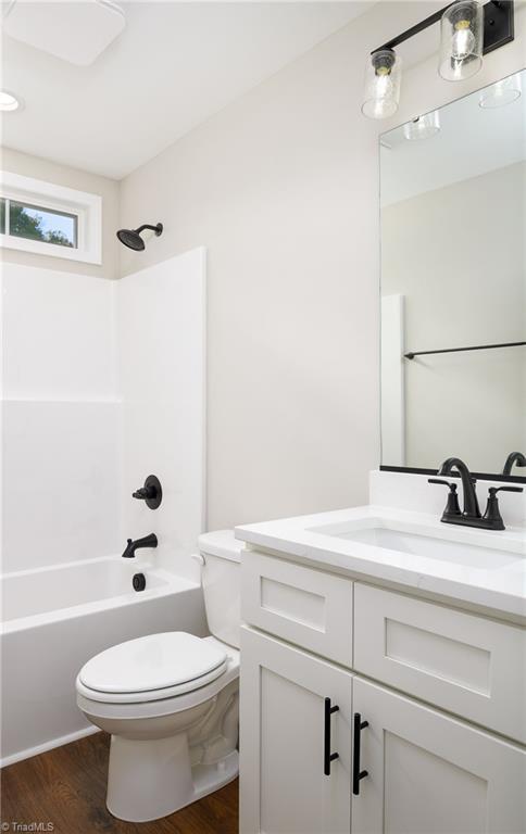 3902 NC Highway 47, Lexington, NC 27292 - full bathroom featuring vanity, wood finished floors, and shower / bath combination