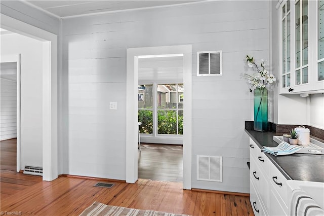 corridor with light wood-style flooring and washer / clothes dryer