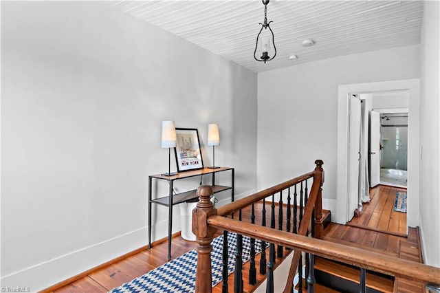 stairway featuring hardwood / wood-style flooring and baseboards