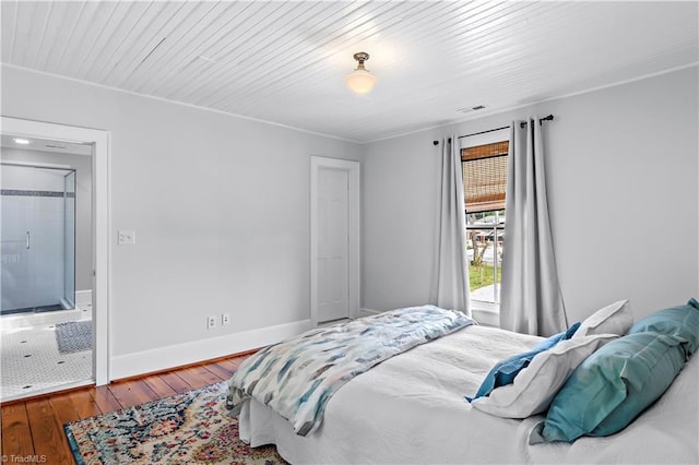 bedroom featuring wood finished floors and baseboards