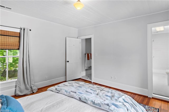 bedroom featuring wood finished floors and baseboards
