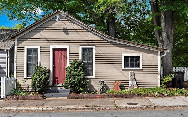 bungalow-style home with fence