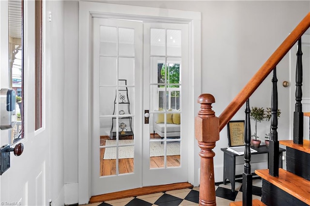 entryway with tile patterned floors and stairs