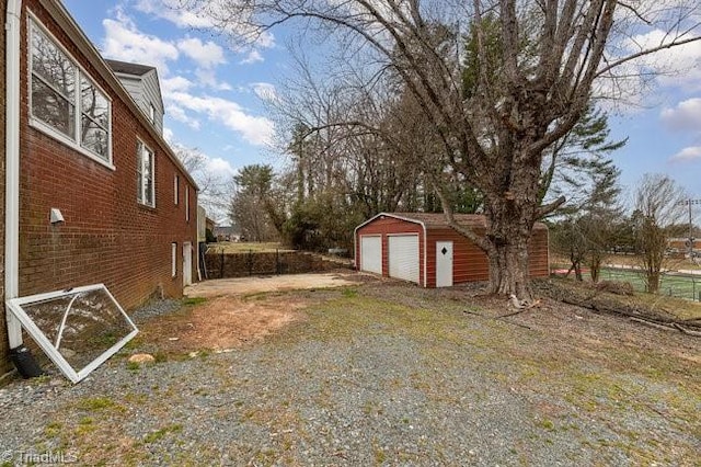 view of yard featuring an outbuilding and a detached garage