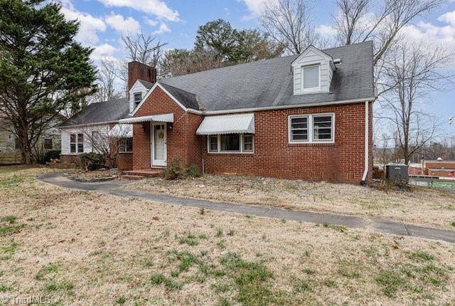 cape cod home with brick siding